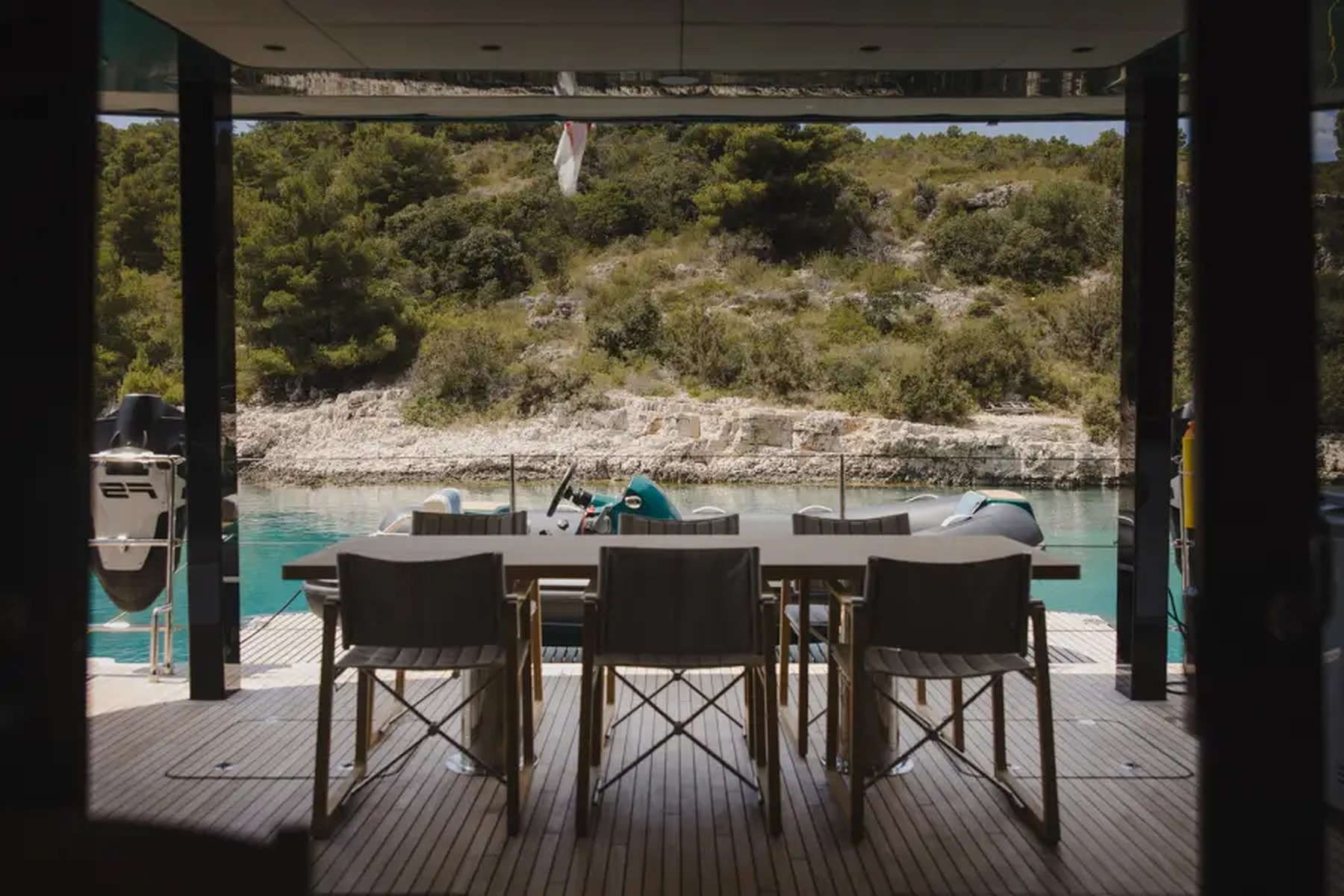 A candlelit dinner table on the aft deck of a sailing yacht at dusk