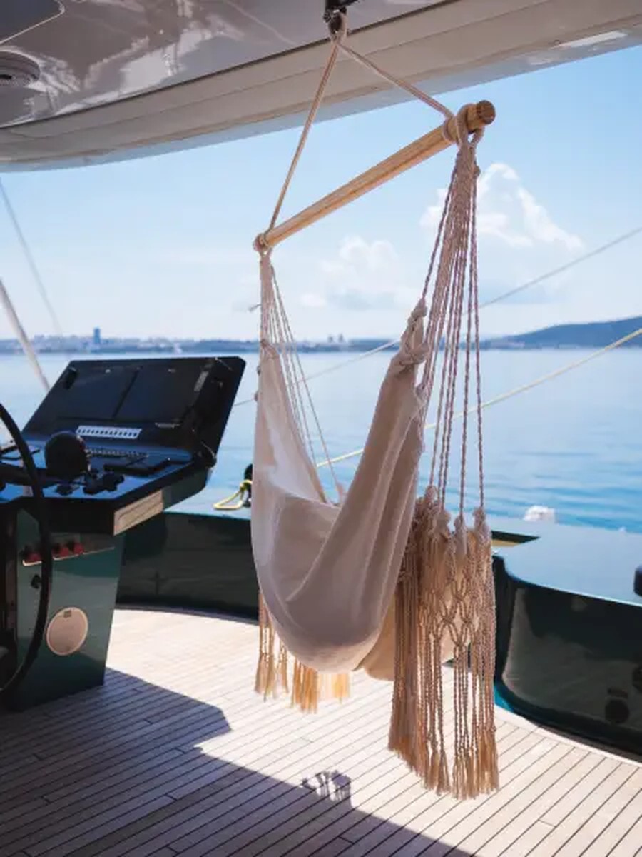 The shaded foredeck of Midori with hammocks stretched between the hulls