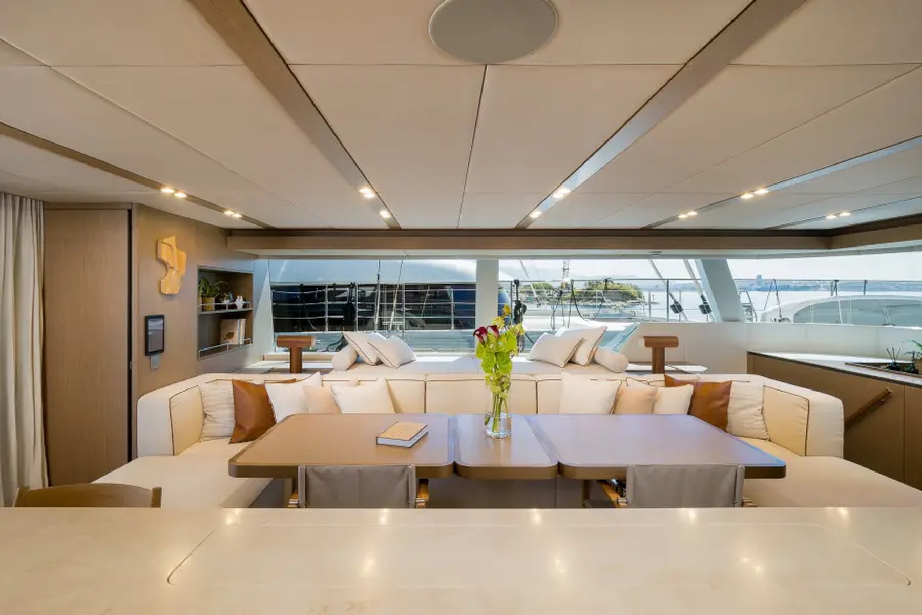 The open salon and dining area aboard Midori, looking out over the water